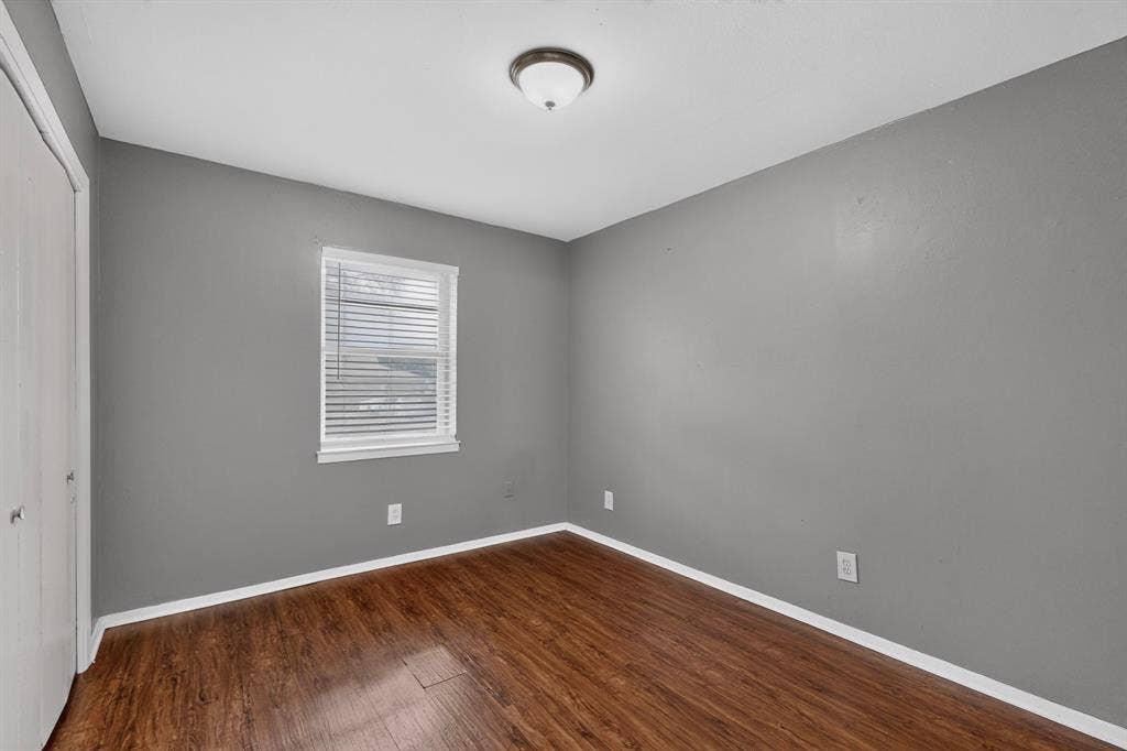 101 Spinner Circle, DeSoto, TX 75115 Wood-finish flooring with white trim, gray painted walls, and a white window with blinds