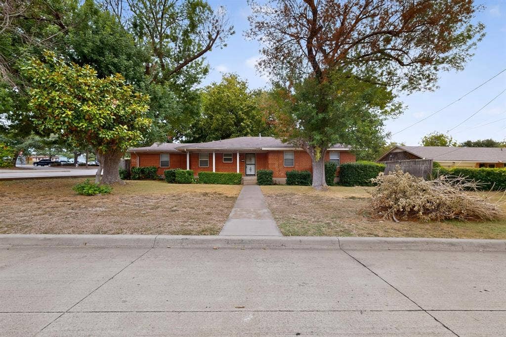 101 Spinner Circle, DeSoto, TX 75115 Brick exterior with white columns and a covered porch