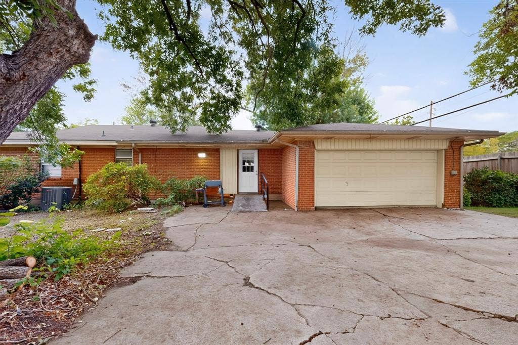 101 Spinner Circle, DeSoto, TX 75115 Brick exterior with an attached garage, white garage door, and a white entry door