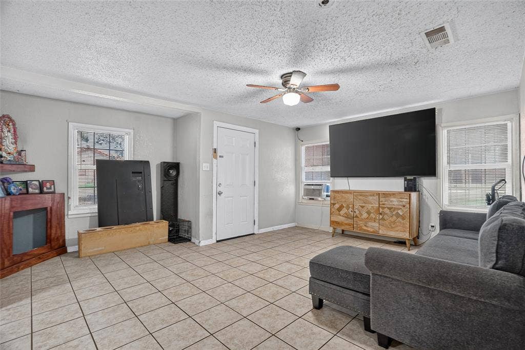 5800 Dallas Avenue, Fort Worth, TX 76112 Tile flooring, ceiling fan, multiple windows, built-in shelving