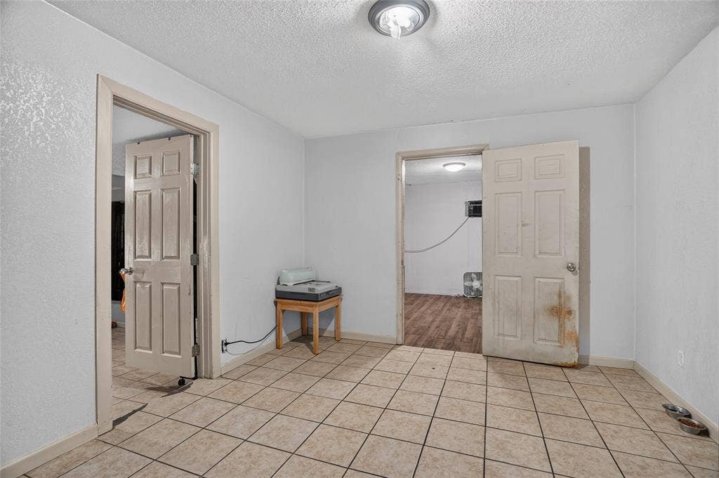 5800 Dallas Avenue, Fort Worth, TX 76112 Tiled flooring with neutral tones, white painted walls, and a flush-mount ceiling light fixture
