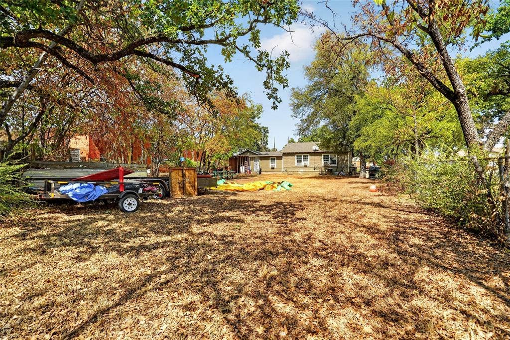5800 Dallas Avenue, Fort Worth, TX 76112 Expansive outdoor space featuring mature trees and a residential structure