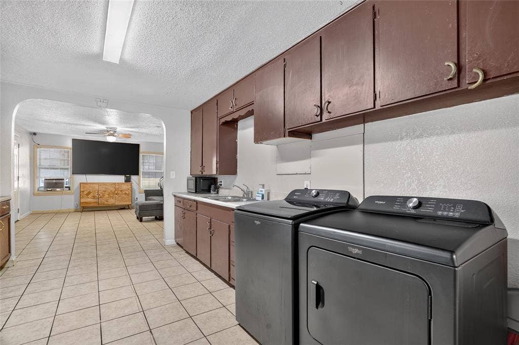 5800 Dallas Avenue, Fort Worth, TX 76112 Tile flooring, built-in cabinetry, arched entryway, and a ceiling fan