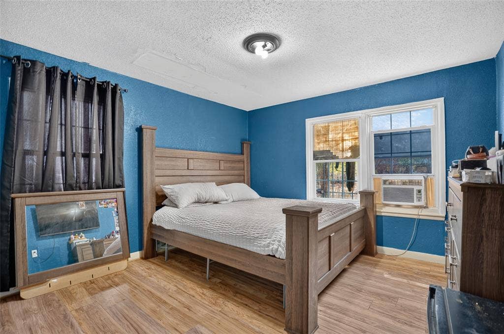 5800 Dallas Avenue, Fort Worth, TX 76112 Wood-finish flooring with a textured wall finish