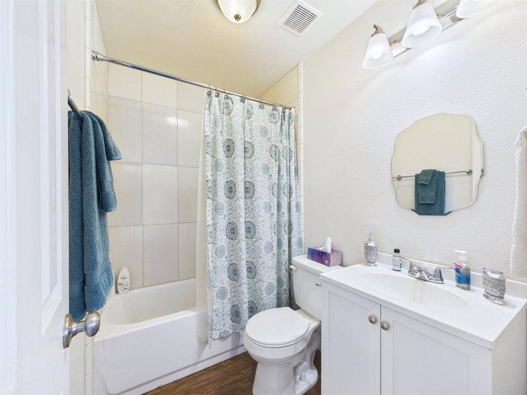 9335 Whittenburg Gate, Dallas, TX 75243 White vanity with an integrated sink and chrome faucet