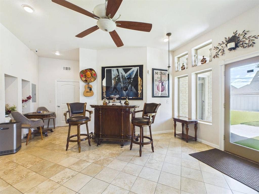 9335 Whittenburg Gate, Dallas, TX 75243 Tile flooring, ceiling fan, recessed lighting, built-in wall niches, and multiple windows