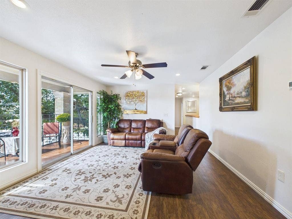 9335 Whittenburg Gate, Dallas, TX 75243 Recessed lighting, ceiling fan, wood-finish flooring, sliding glass door, and an outdoor balcony with railings