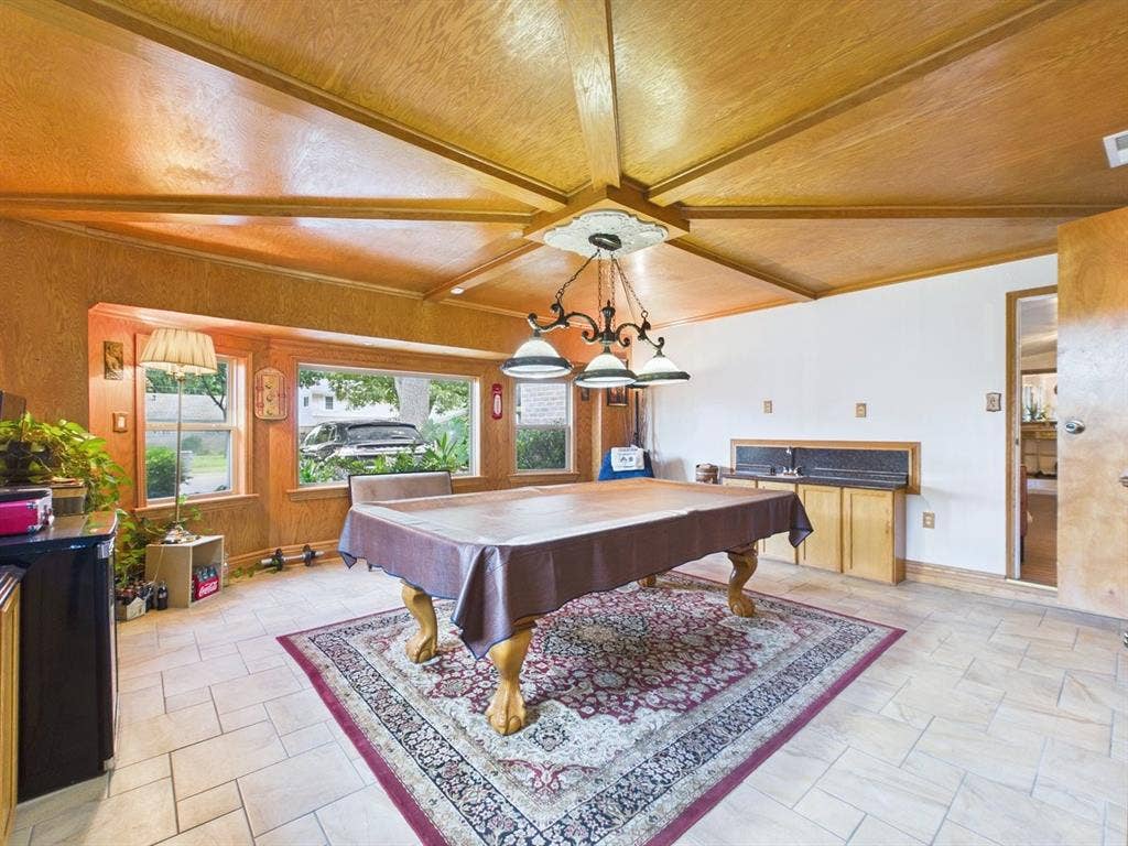 9335 Whittenburg Gate, Dallas, TX 75243 Wood-paneled ceiling with exposed beams, tile flooring, built-in wet bar with wood cabinetry, and multiple windows