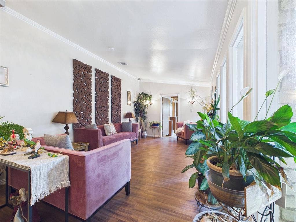 9335 Whittenburg Gate, Dallas, TX 75243 Wood-finish flooring throughout the open layout with crown molding