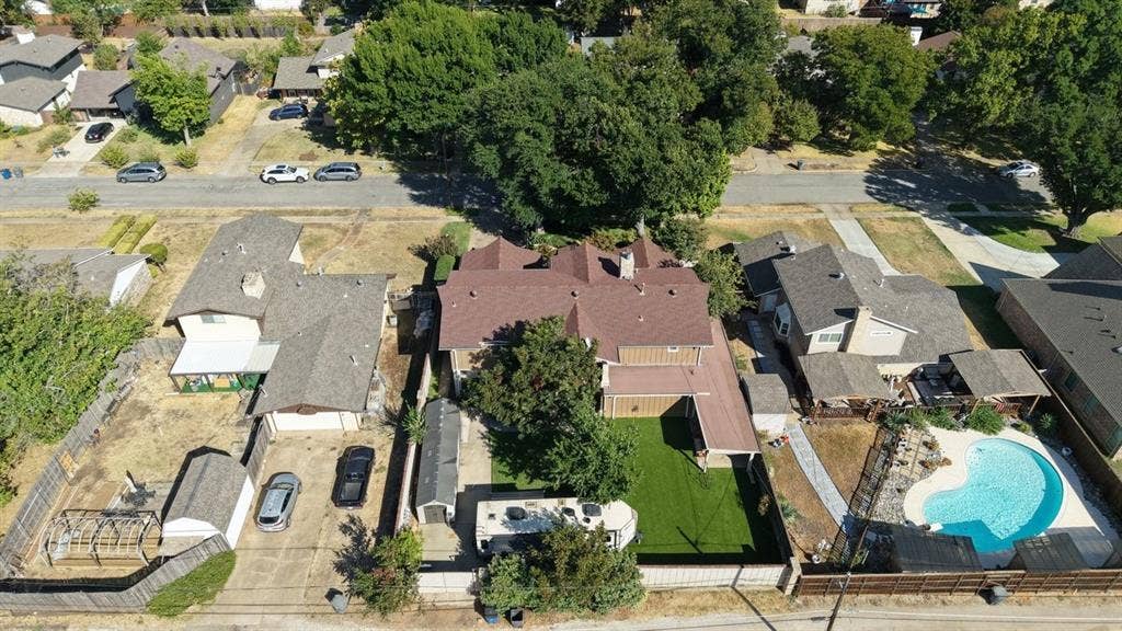 9335 Whittenburg Gate, Dallas, TX 75243 Expansive property with a large main residence, a detached garage, a substantial swimming pool, and an artificial turf lawn