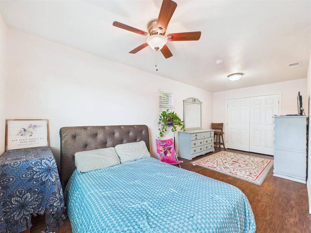 9335 Whittenburg Gate, Dallas, TX 75243 Wood-finish flooring, ceiling fan with integrated lighting, white walls, and white bi-fold closet doors