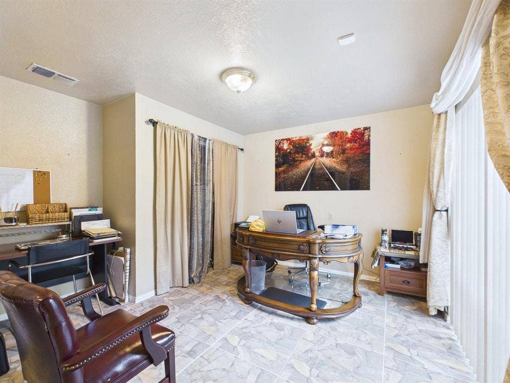 9335 Whittenburg Gate, Dallas, TX 75243 Recessed lighting, tile flooring, vertical blinds, and a built-in desk area