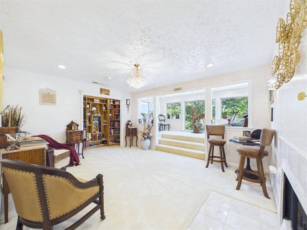 9335 Whittenburg Gate, Dallas, TX 75243 Recessed lighting, built-in shelving, chandelier, and a stepped entry