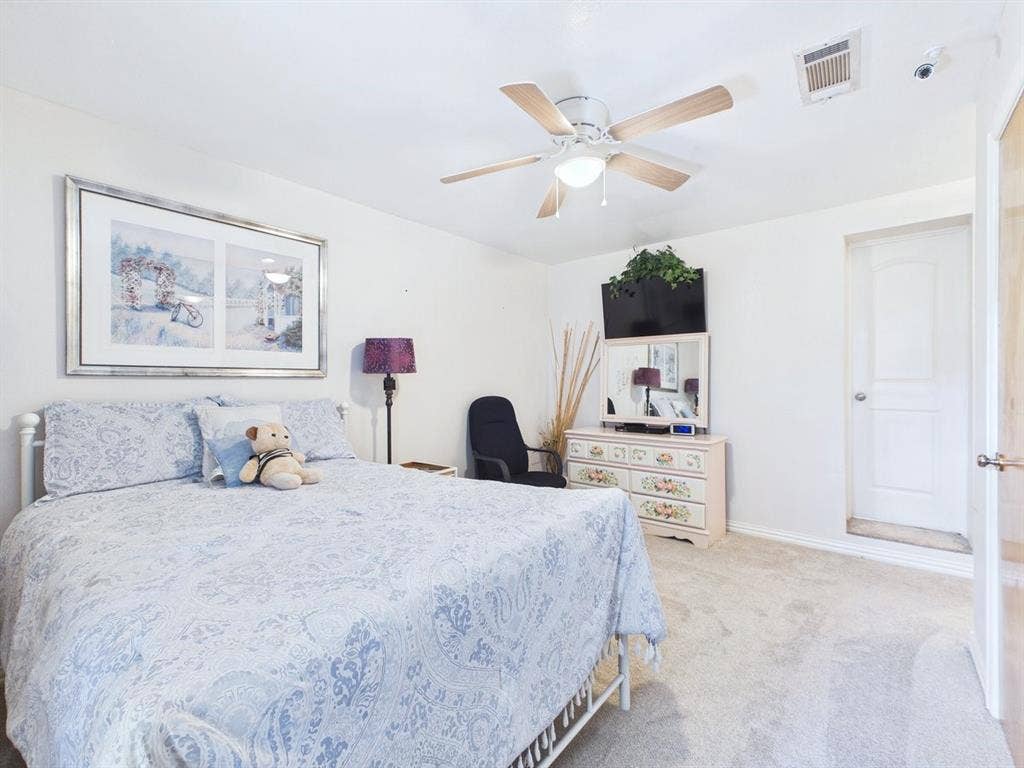 9335 Whittenburg Gate, Dallas, TX 75243 Ceiling fan with integrated lighting, wall-to-wall carpeting, and a solid core door