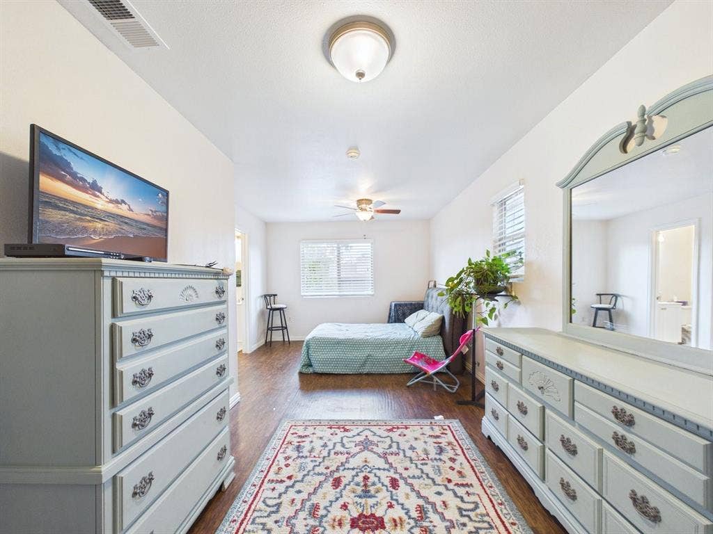9335 Whittenburg Gate, Dallas, TX 75243 Wood-finish flooring throughout, ceiling-mounted light fixture, window with blinds, and a ceiling fan
