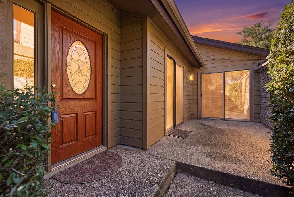 Wood-paneled entry door with glass insert