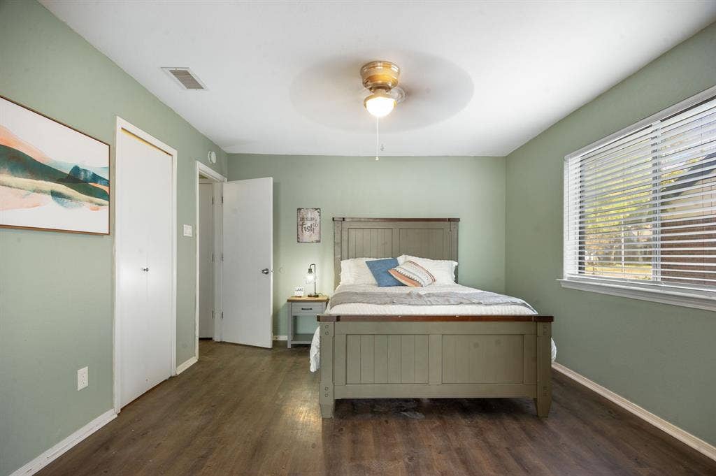 Irving, TX 75060 Hardwood-look flooring, ceiling fan, window with blinds, and white doors