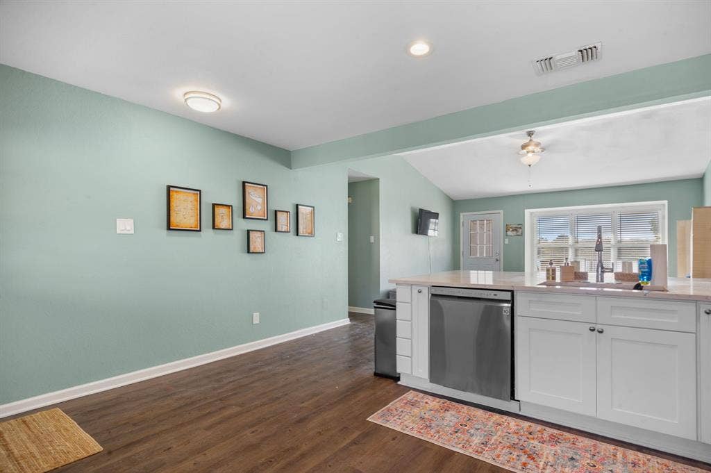 Irving, TX 75060 Kitchen island with light-toned countertops and white cabinetry