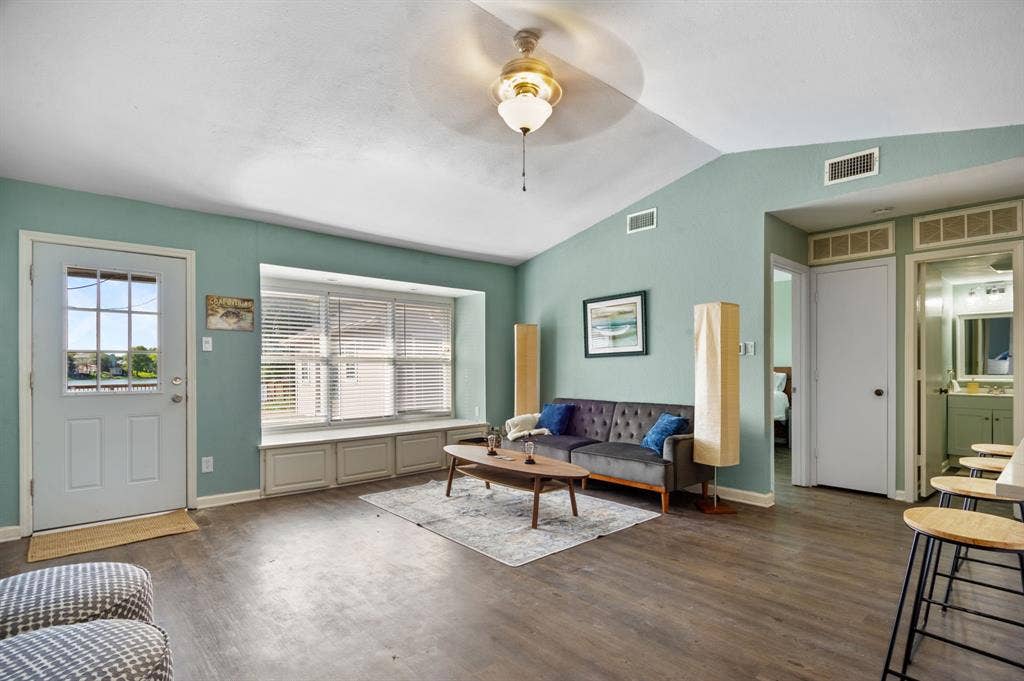 Irving, TX 75060 Vaulted ceiling, wood-finish flooring, built-in window seating, transom windows, and an exterior glass-panel door