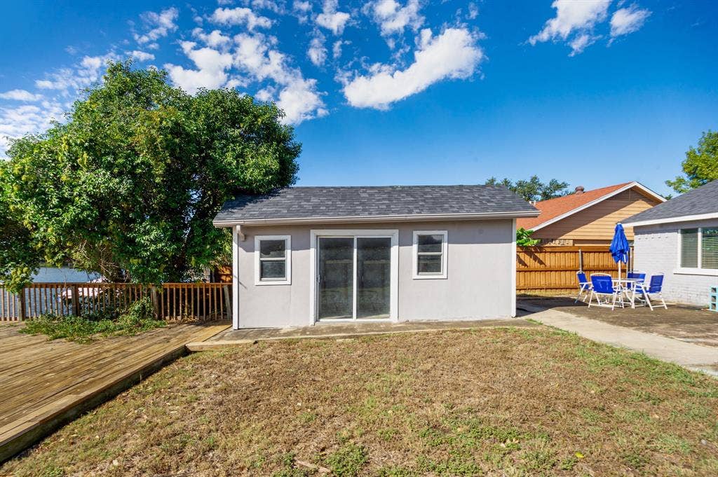 Irving, TX 75060 Detached structure with sliding glass doors and a shingle roof