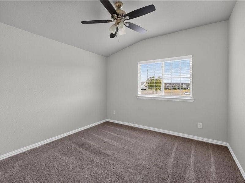 Vaulted ceiling with a ceiling fan, neutral wall paint, window with blinds, and carpeted flooring