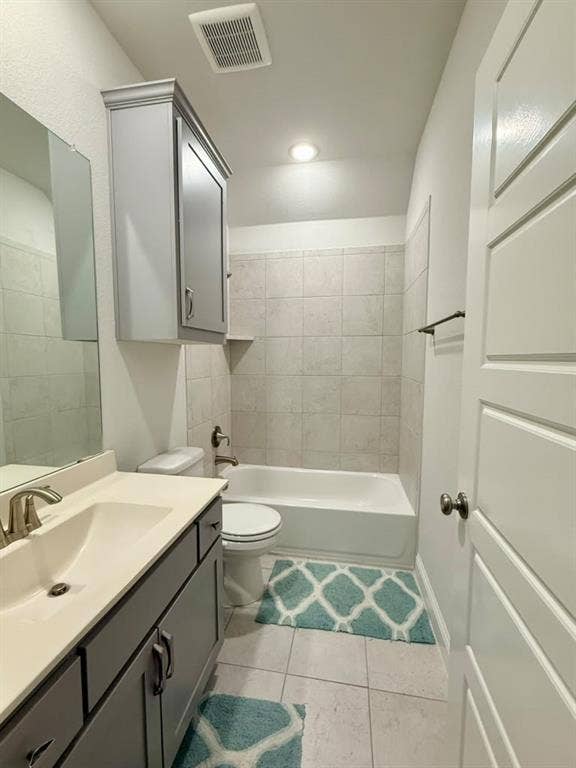 Bathroom featuring a vanity with an integrated sink, a built-in tub with tile surround, a wall-mounted medicine cabinet, and a panel door