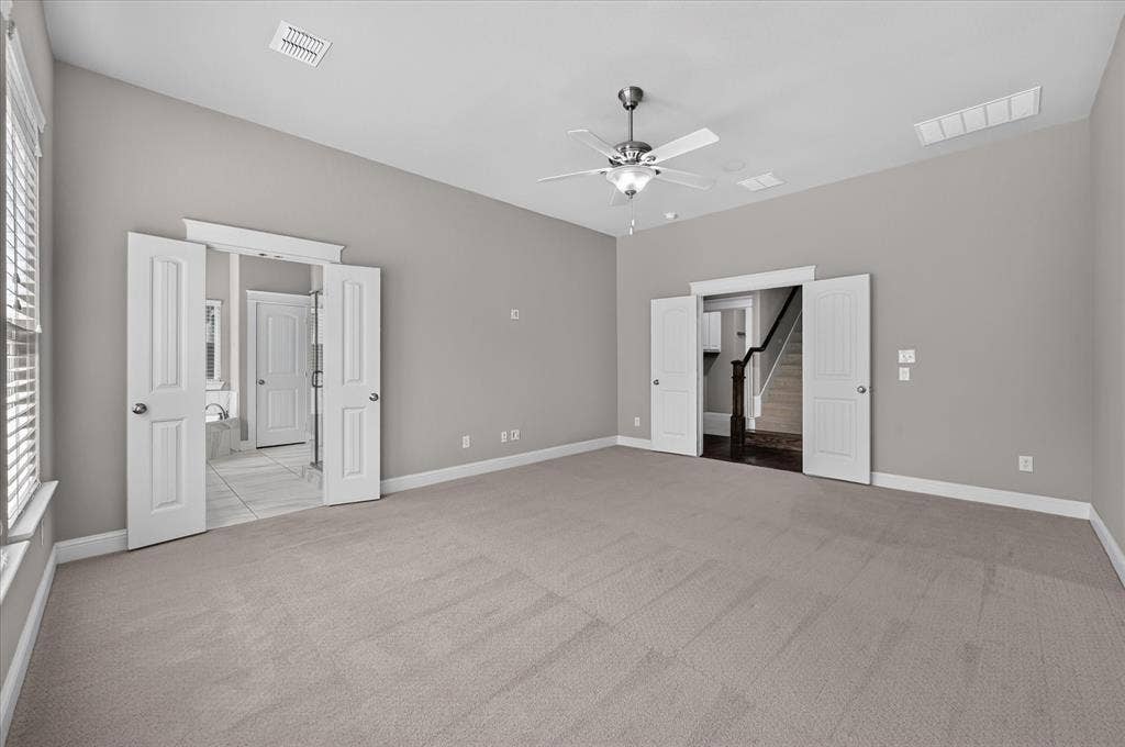 Vaulted ceilings with a ceiling fan, carpet flooring, window with horizontal blinds, white trim, and light gray wall paint