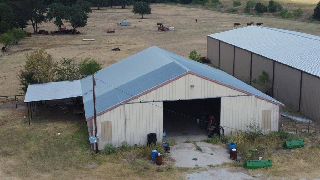 Metal barn structure with a pitched roof and covered side extension