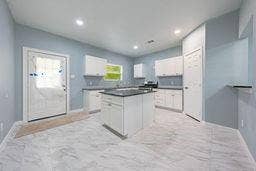 12770 E US 175 E, Larue, TX 75770 Kitchen featuring white cabinetry, a center island with a dark countertop, recessed lighting, and tile flooring