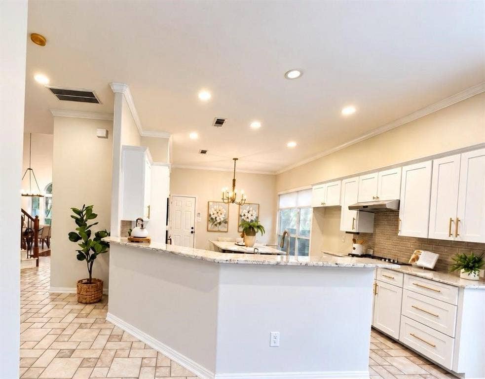 2917 Waterford Drive, Irving, TX 75063 Kitchen featuring white shaker-style cabinetry, granite countertops, a built-in range hood, a tile backsplash, and recessed lighting