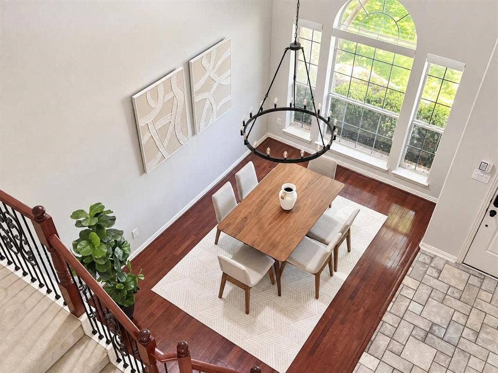 2917 Waterford Drive, Irving, TX 75063 Two-story ceiling, arched window, wood-finish flooring, wrought iron chandelier, and tile flooring