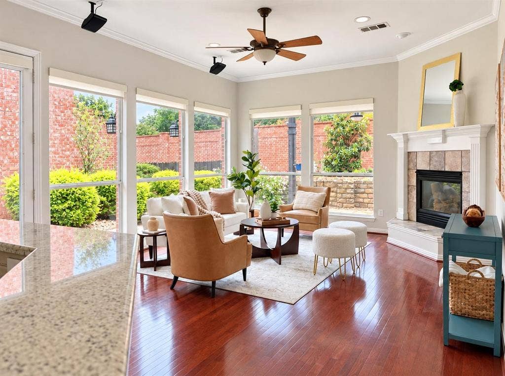 2917 Waterford Drive, Irving, TX 75063 Living area featuring rich wood-finish flooring, a ceiling fan, and multiple windows