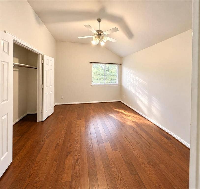 2917 Waterford Drive, Irving, TX 75063 Vaulted ceiling with a ceiling fan, wood-finish flooring, window with blinds, and a closet with bifold doors