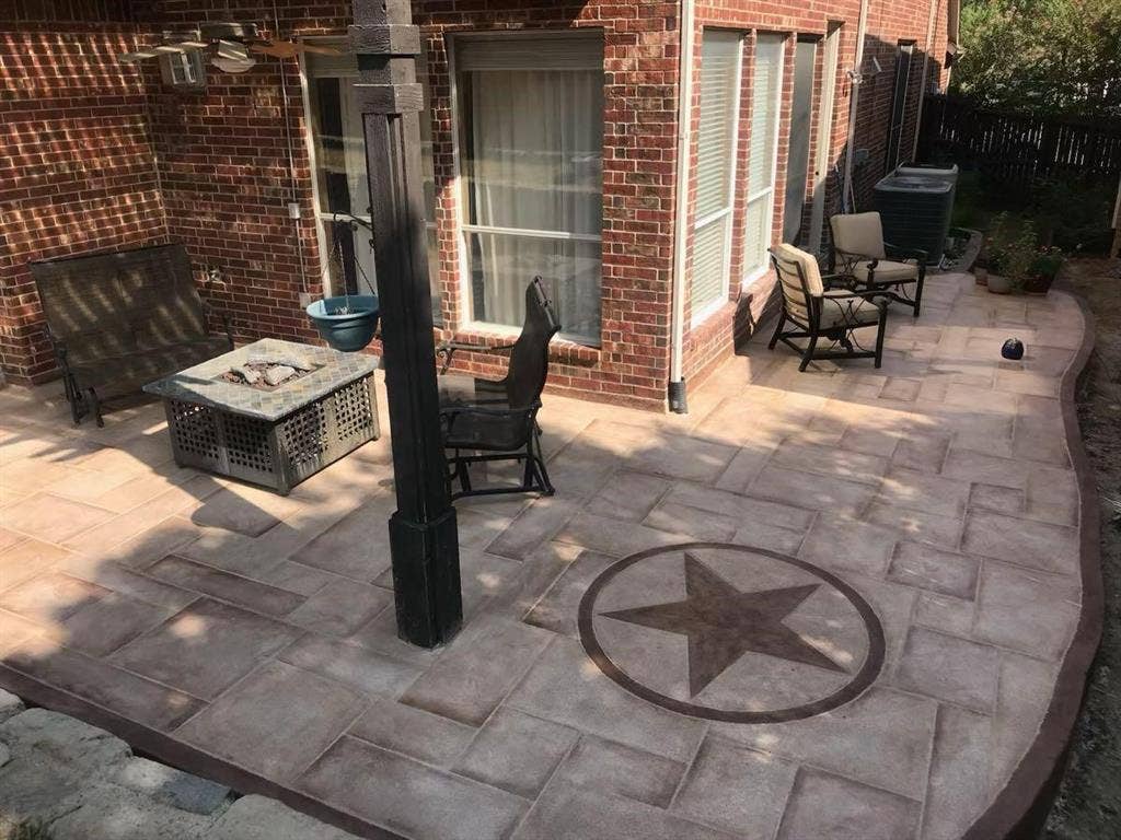 2917 Waterford Drive, Irving, TX 75063 Expansive patio featuring a decorative star inlay, brick exterior, and a built-in ceiling fan