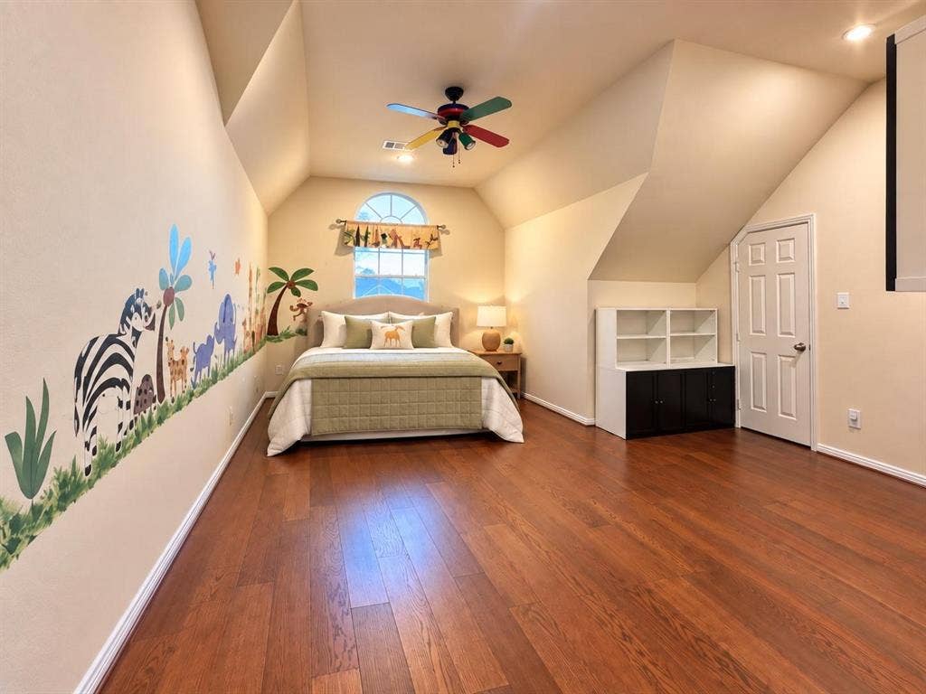 2917 Waterford Drive, Irving, TX 75063 Wood-finish flooring, vaulted ceilings, arched window, built-in shelving, and a ceiling fan