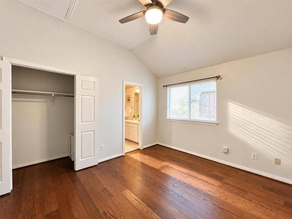 2917 Waterford Drive, Irving, TX 75063 Vaulted ceiling with an attached ceiling fan, hardwood flooring, and a double-door closet