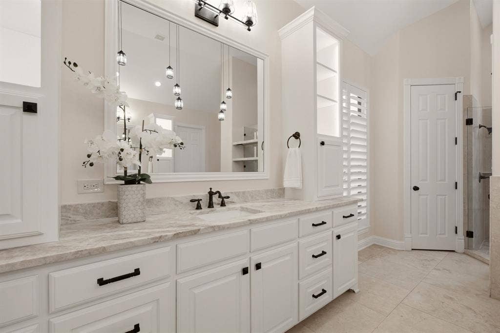 1120 Twin Oaks Drive, Prosper, TX 75078 Equally impressive storage towers for your linens & toiletries. More Travertine floors.