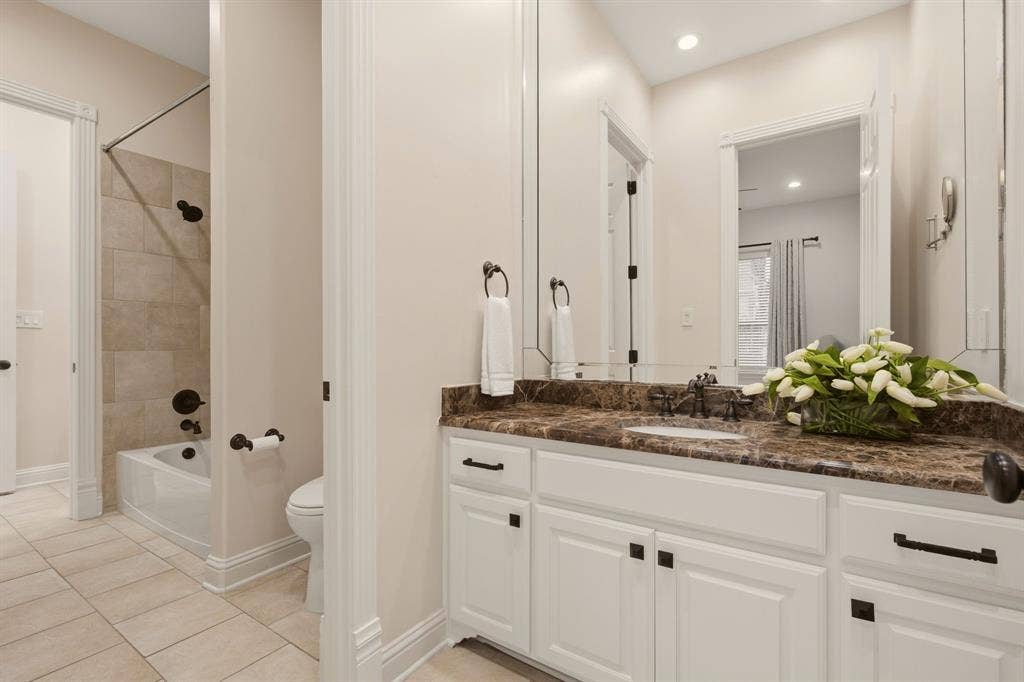 1120 Twin Oaks Drive, Prosper, TX 75078 Shared full bath between bedrooms 3 & 4, each with a wide granite countertop & ample storage.