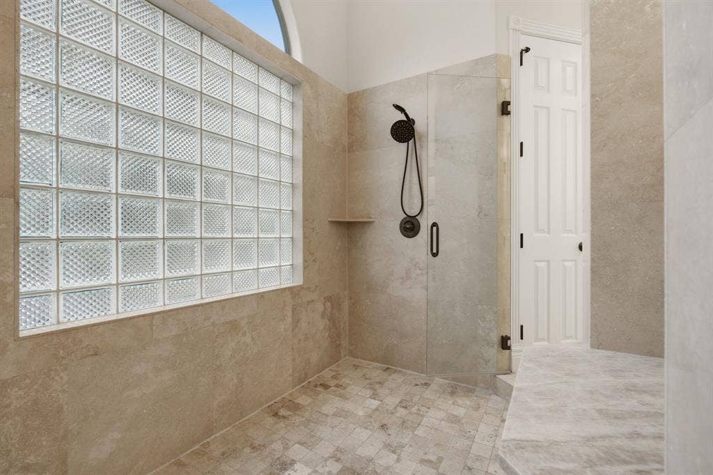 1120 Twin Oaks Drive, Prosper, TX 75078 Enhancing the spa experience, the massive walk-in shower has frameless doors on each entry side.