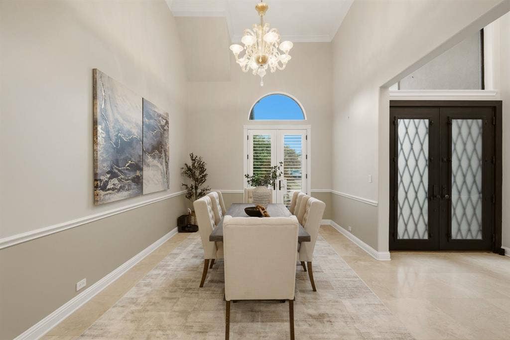 1120 Twin Oaks Drive, Prosper, TX 75078 Featuring a formal dining room designed to accommodate any table shape, making it ideal for both intimate dinners or larger gatherings. Note the stunning multi-tiered Murano glass chandelier, with a complimentary one in the foyer.