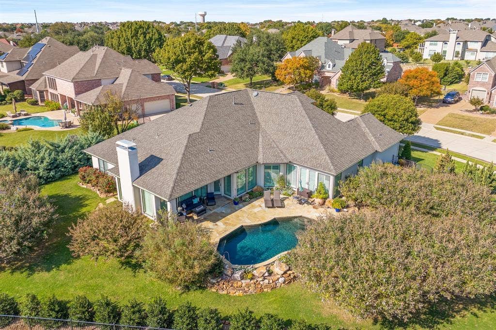 1120 Twin Oaks Drive, Prosper, TX 75078 A resort-style swimming pool anchors the backyard, complemented by generous patio space & lush greenery that enhances the home's secluded feel. Properties of this size & caliber in such a great Prosper location are increasingly uncommon, making this an opportunity that truly stands out.