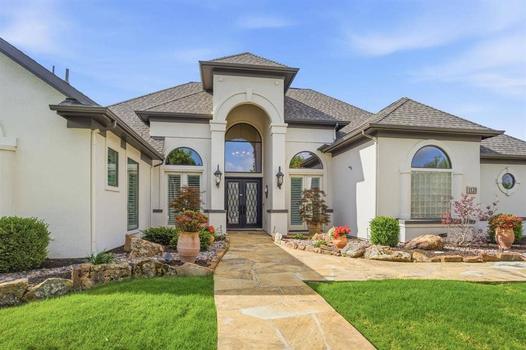 1120 Twin Oaks Drive, Prosper, TX 75078 From the moment you arrive, this Twin Oaks home's curb appeal makes a lasting impression. A grand set of double wrought iron front doors serve as the focal point, combining timeless craftsmanship with an inviting sense of arrival. Come on in!