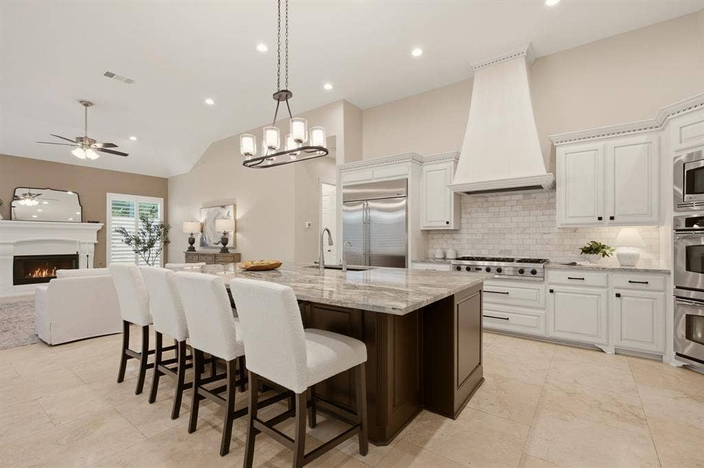 1120 Twin Oaks Drive, Prosper, TX 75078 A beautifully redesigned luxury kitchen boasts many upgrades. Among them: high-end Fusion Quartzite countertops + on the massive island. Handy pull-out drawers under the island too for seasonal serving pieces.