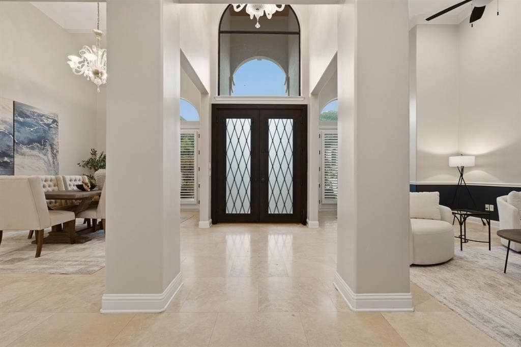 1120 Twin Oaks Drive, Prosper, TX 75078 A residence of character & individuality, the architectural dimensions that separate each room also add to seamless flow from front to back. High-end Travertine floors & elevated ceilings in the foyer create a sense of openness & sophistication, while thoughtfully curated upgrades reflect the level of detail today's luxury buyers expect.