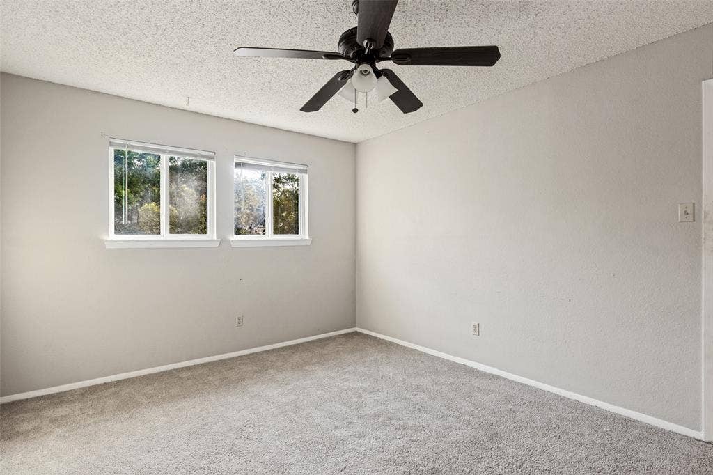 12206 Tyson Cove, #A, Austin, TX 78758 Recessed windows with blinds, ceiling fan with integrated lighting, neutral wall paint, and gray carpeting