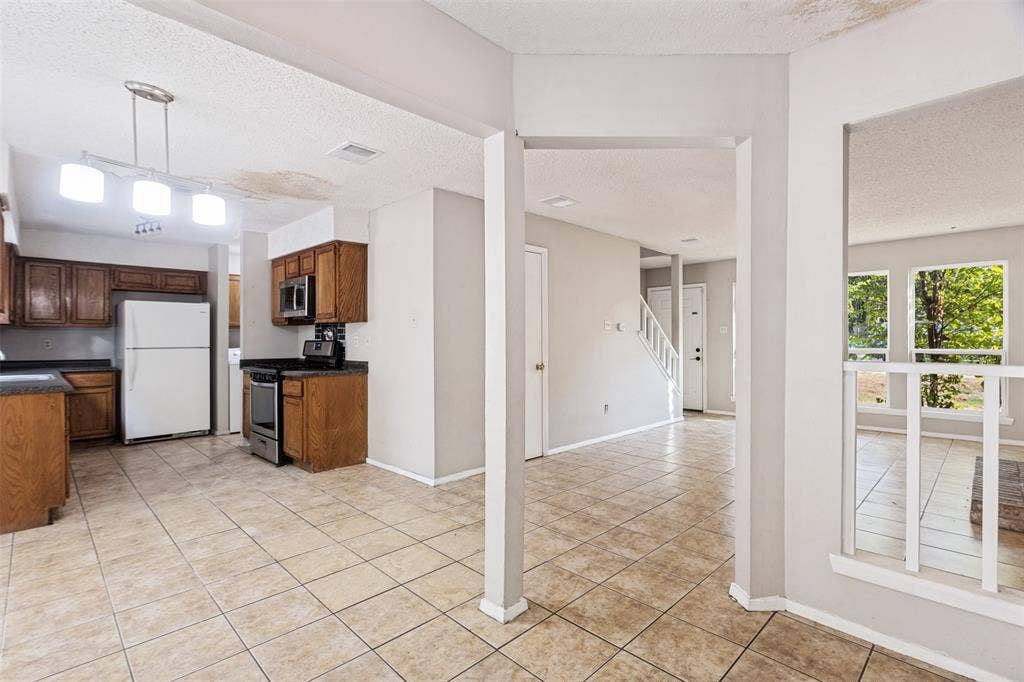 12206 Tyson Cove, #A, Austin, TX 78758 Kitchen with wood cabinetry, stainless steel appliances, and tile flooring