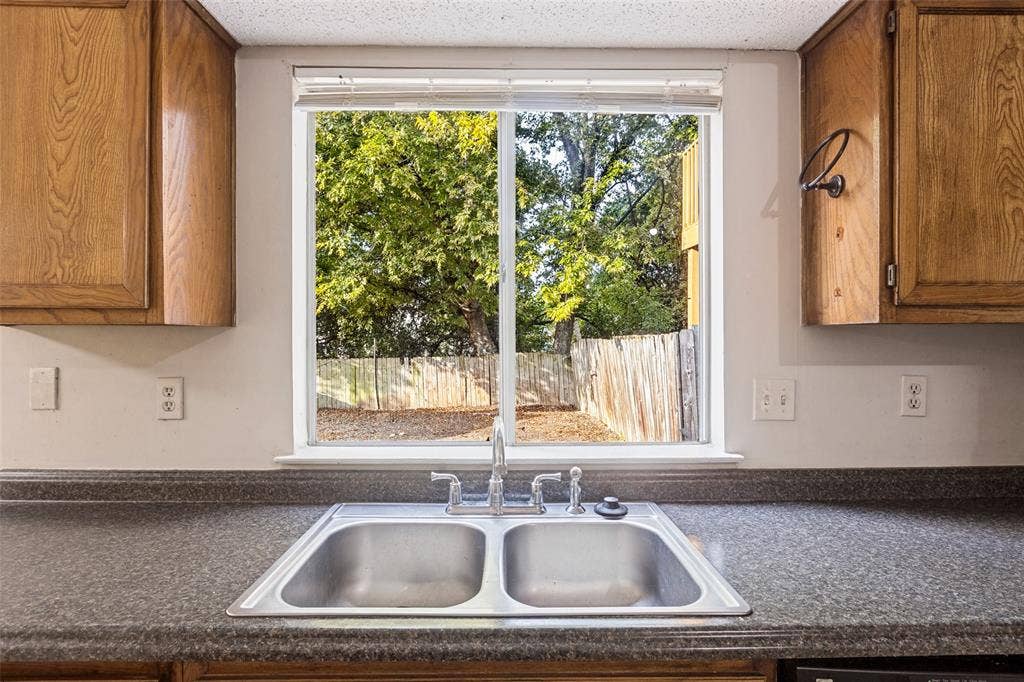 12206 Tyson Cove, #A, Austin, TX 78758 Double basin stainless steel sink with a chrome faucet