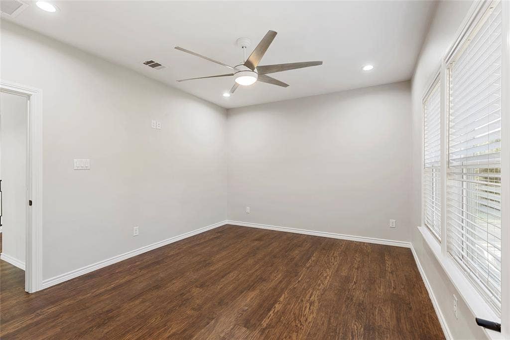 702 Linkcrest Drive, Duncanville, TX 75137 Wood-finish flooring, two large windows with blinds, recessed ceiling lighting, and a modern ceiling fan