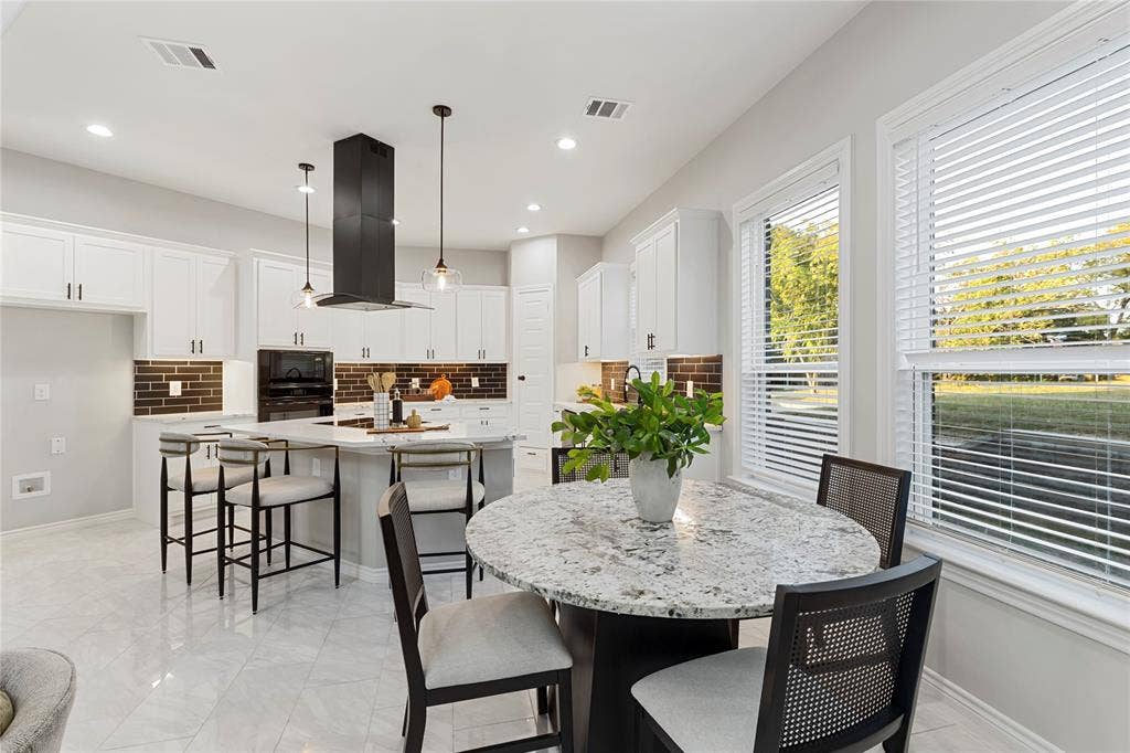 702 Linkcrest Drive, Duncanville, TX 75137 White cabinetry with dark hardware and a brown brick-patterned backsplash