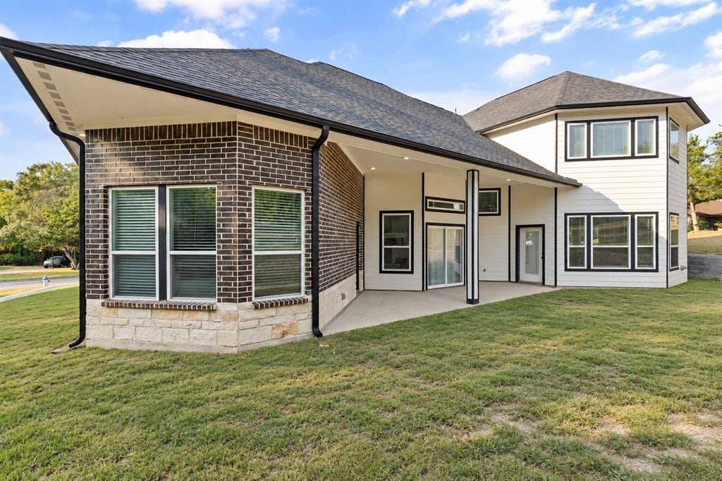 702 Linkcrest Drive, Duncanville, TX 75137 Exterior showcasing dark brick, stone veneer, and white siding
